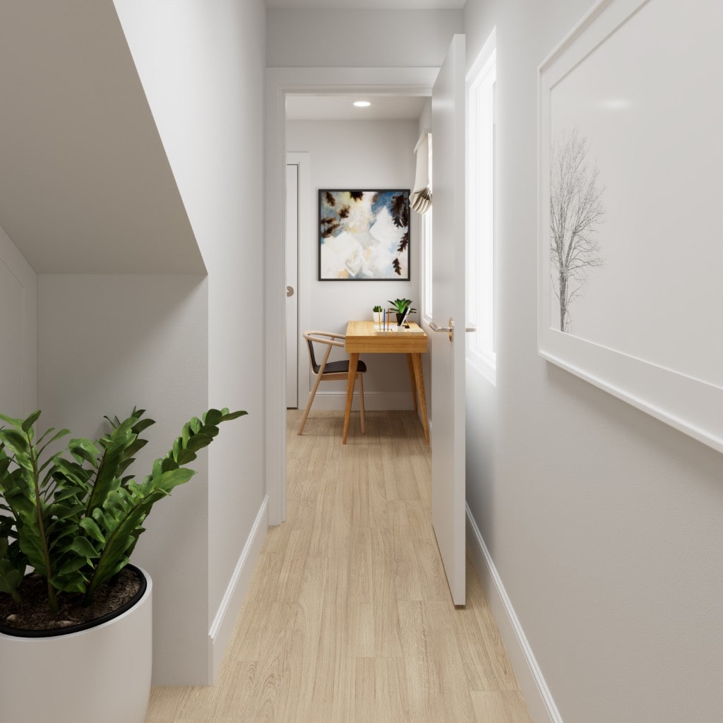 A hallway with light wood flooring leading to an open doorway that reveals a small home office nook with a desk.