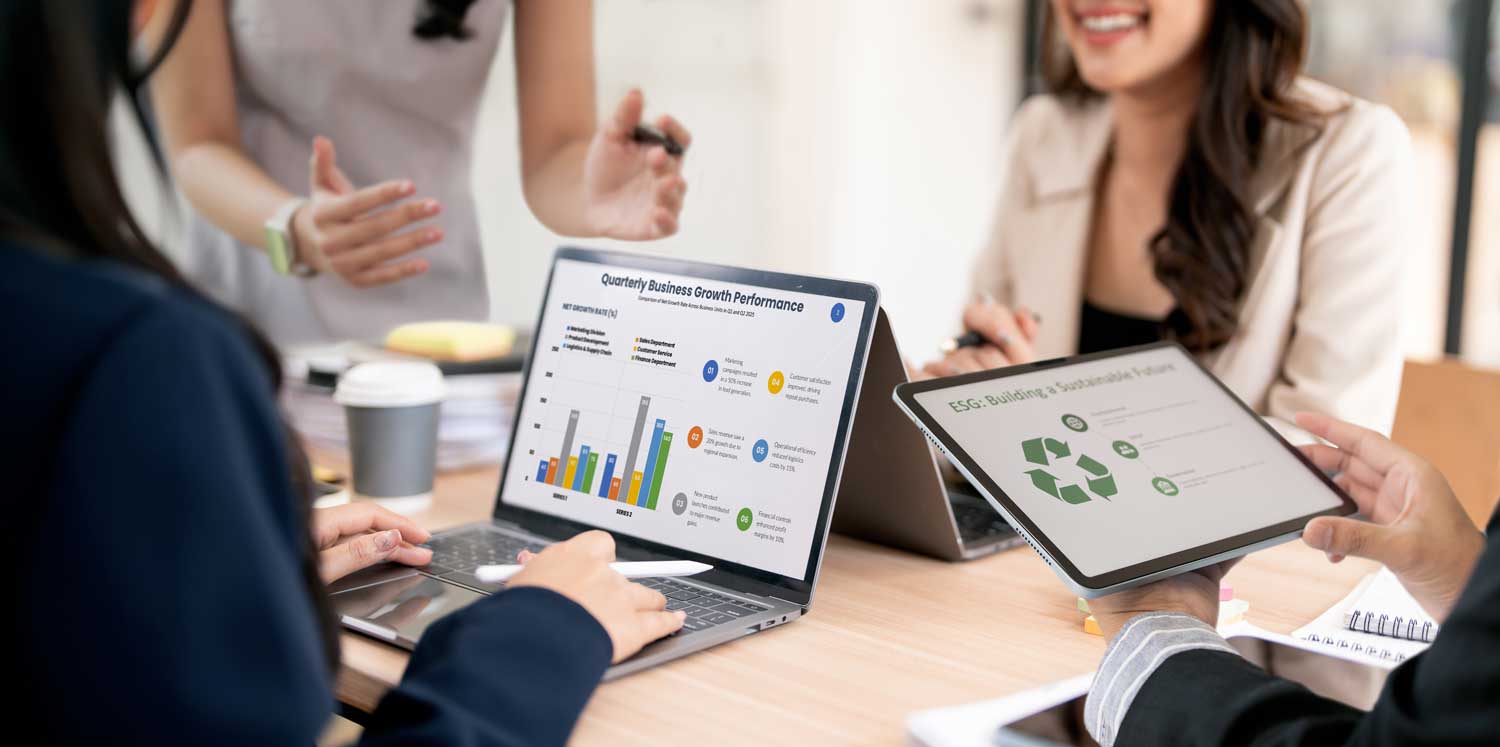 Professionals using laptop and tablet to analyze AI-driven business growth performance and ESG sustainability reports.